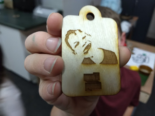 wood cut out with a laser engraved face on it